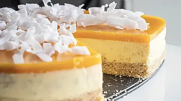Mango and coconut cheesecake with coconut chips sliced