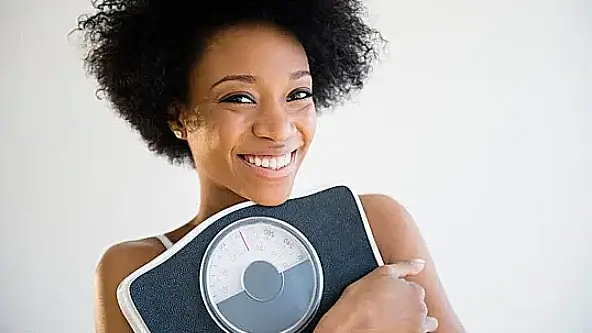 Woman holding a scale