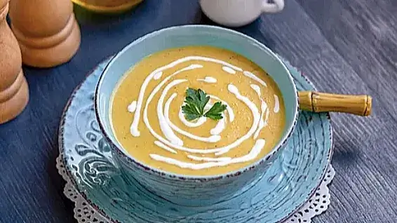 Zucchini and yellow squash soup decorated with parsley and cream